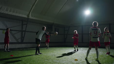 young female soccer players training indoors