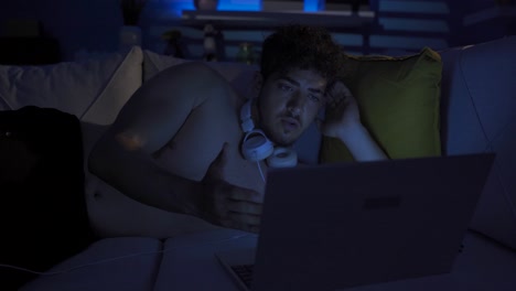 young man looking at laptop in amazement and amazement.