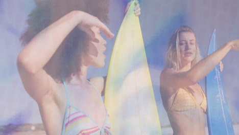 two women surfers holding surfboards on sunny beach, with animated wave icons and travel ad data