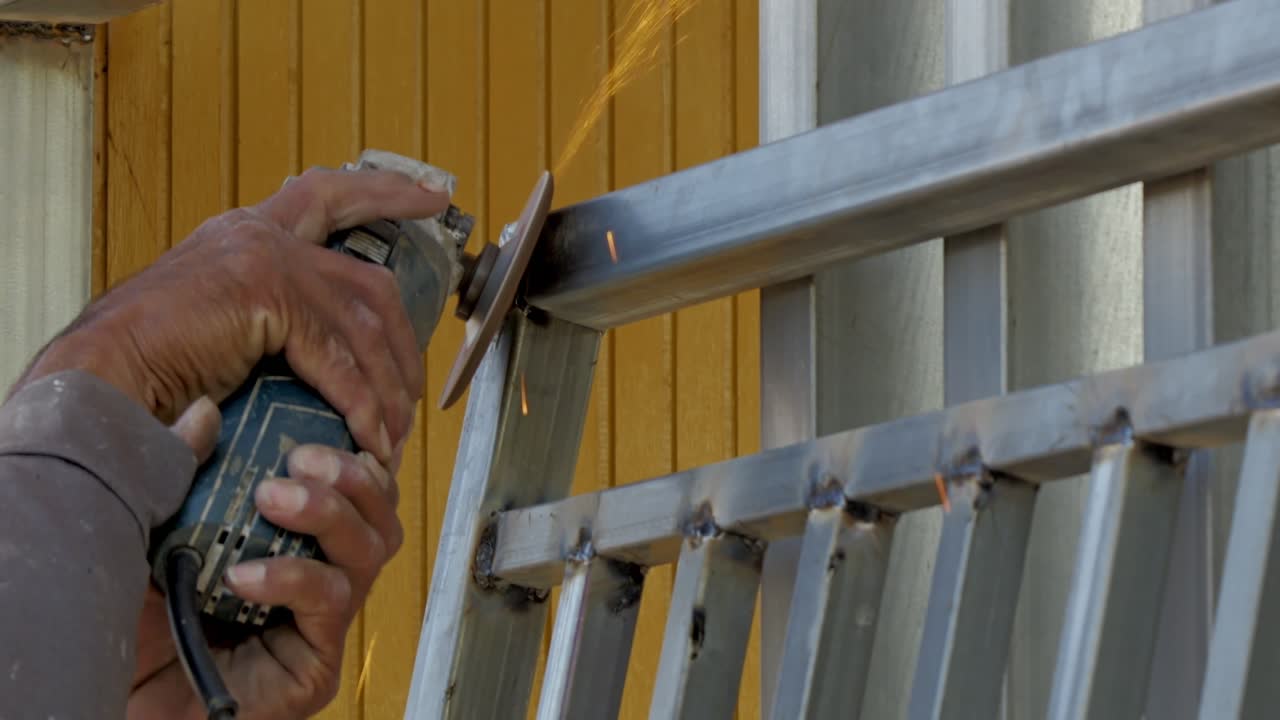 A skilled worker creates sparks while welding metal fixtures in a workshop showcasing craftsmanship