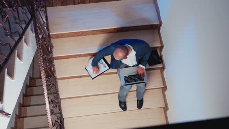 top view of manager typing on notebook