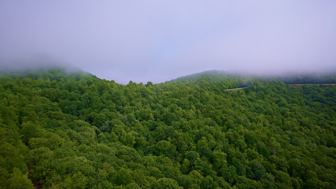 Smooth cinematic drone shot over misty Appalachian ridges