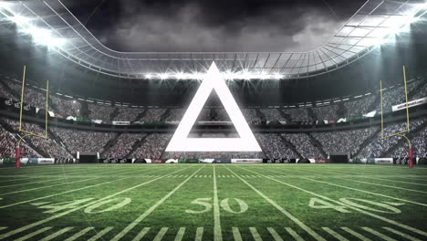 glowing triangle animation hovering above football stadium under dramatic sky