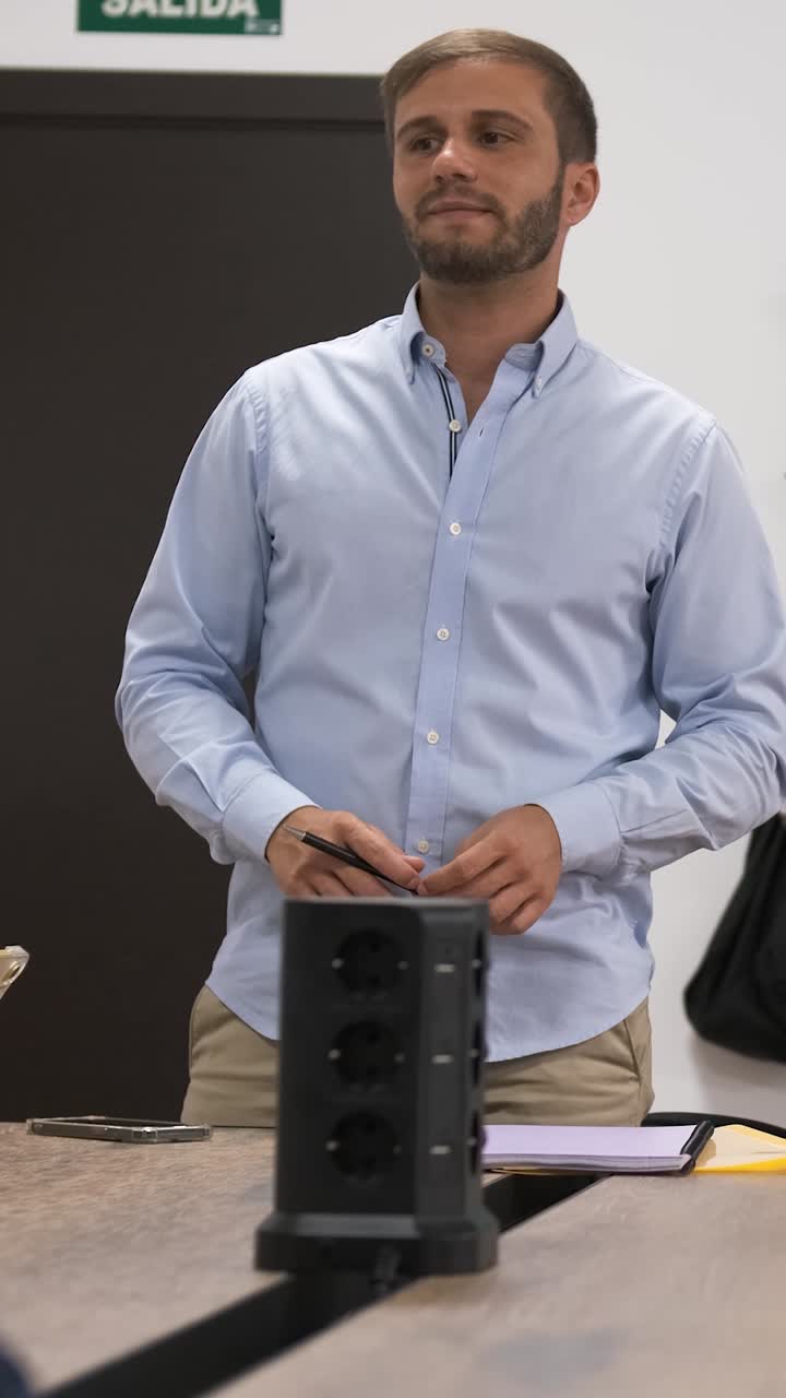 Businessman delivering presentation in meeting room. Vertical footage