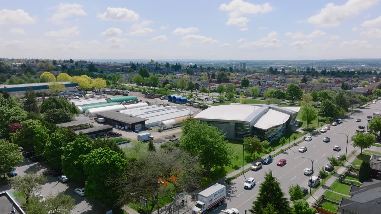 Oakridge Realty Structures In Oakridge, Vancouver, Canada With Fast Moving Traffic In The Forefront