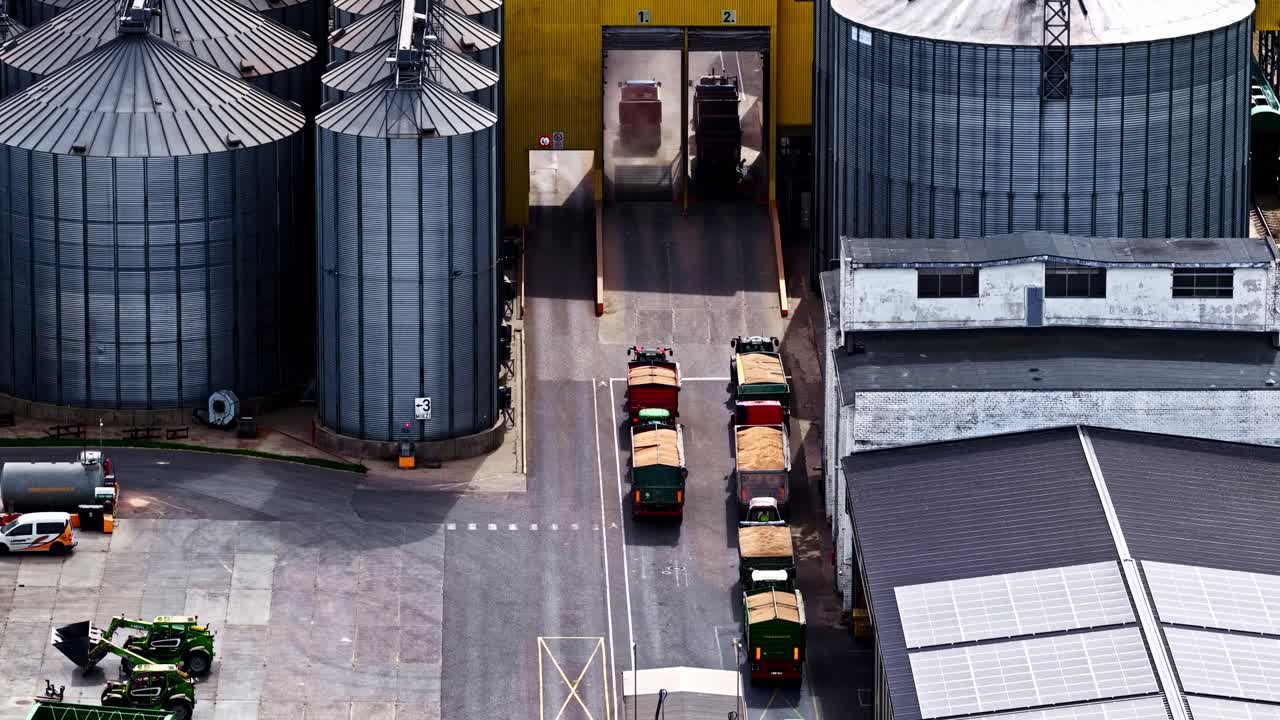 Timelapse of trucks at grain silos, showcasing industrial efficiency