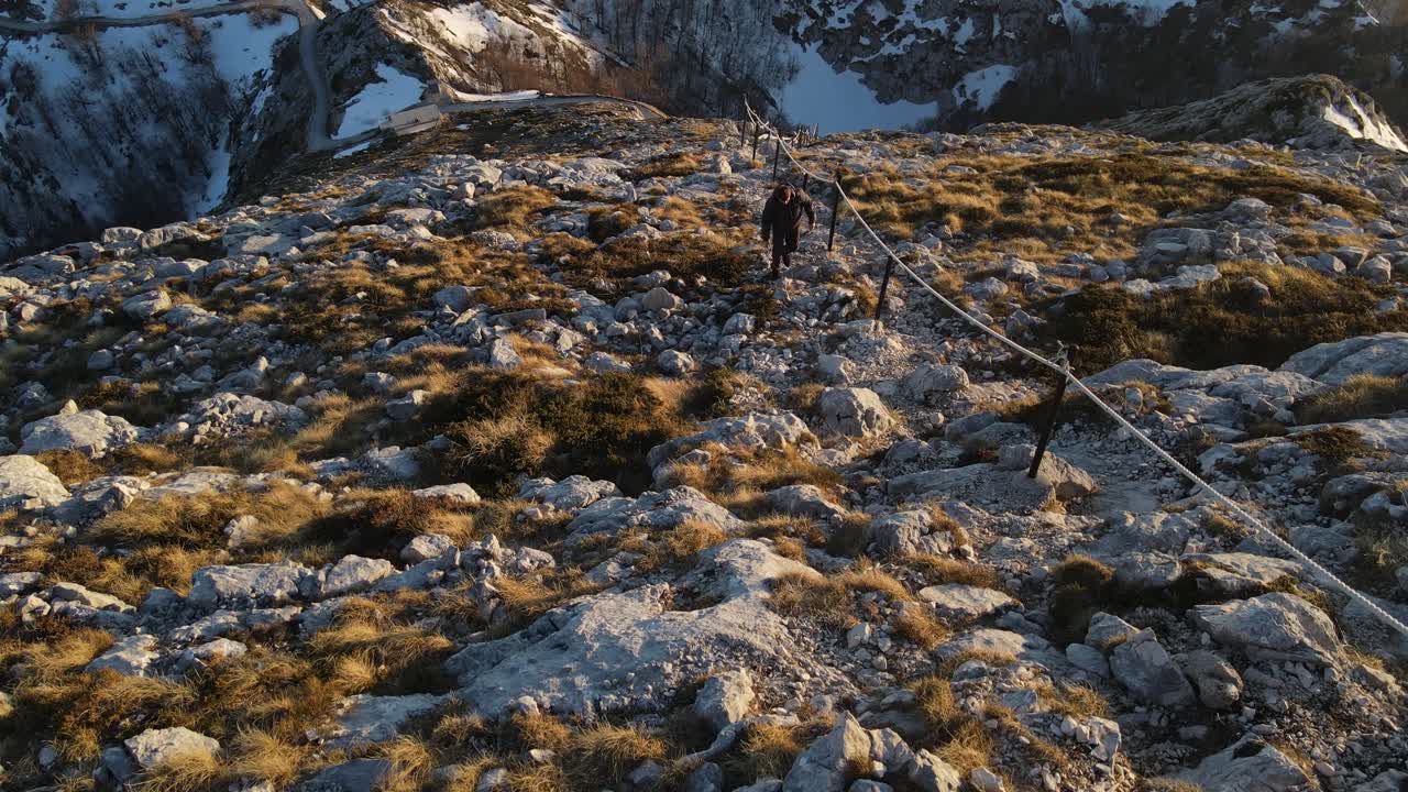 Man ascending rocky hiking trail, Sveti Jure, Park prirode Biokovo. High angle view