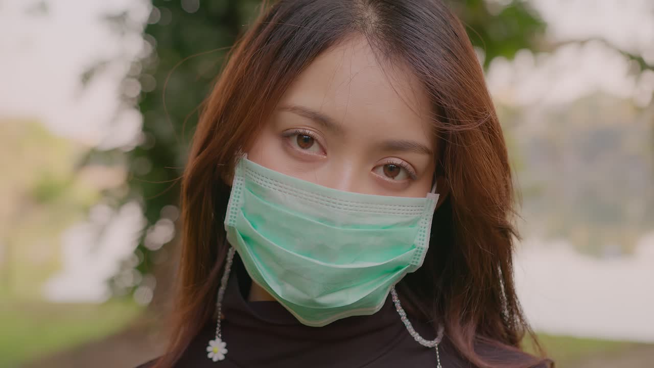 공원에서 얼굴 마스크를 쓰고 있는 여자