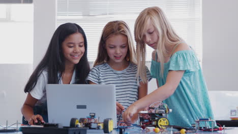 Three-Female-Students-Building-And-Programing-Robot-Vehicle-In-After-School-Computer-Coding-Class