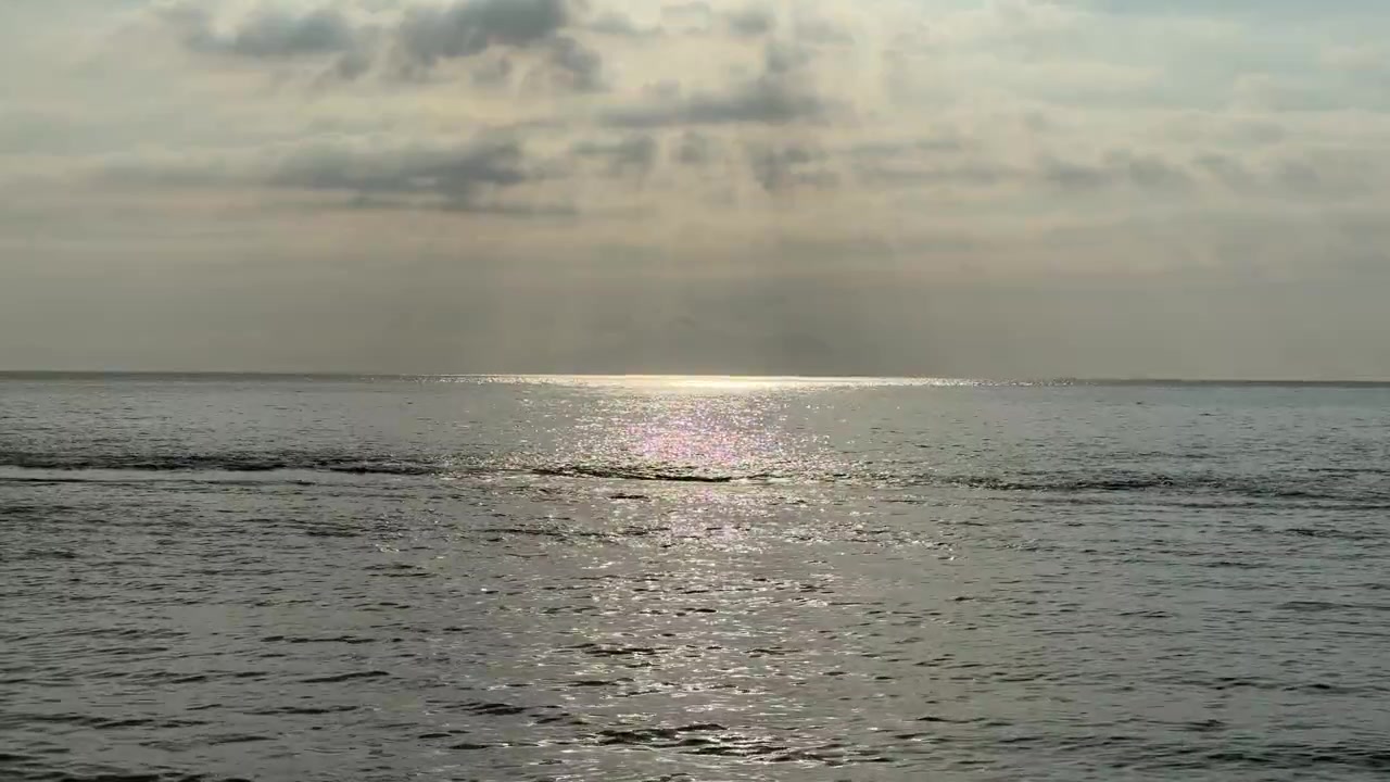 Sunlight Reflecting on Calm Ocean Waves at Sunset