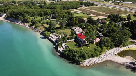 aerial view of a luxury private house estate on the lakefront of an emerald lake