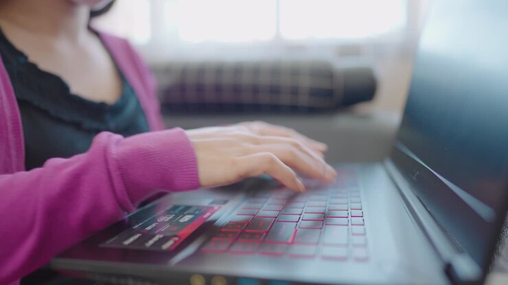 A close-up woman sitting on a sofa Press to type information computer laptop for shopping online at home