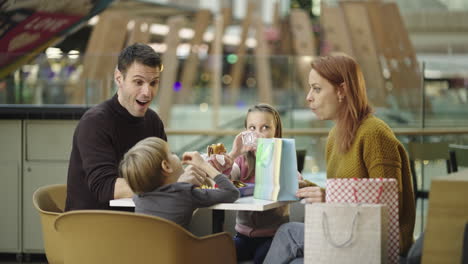 family eating a meal in a shopping mall food court