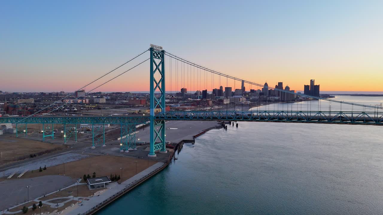 Ambassador Bridge at twilight with Detroit River reflecting soft pastel sky colors