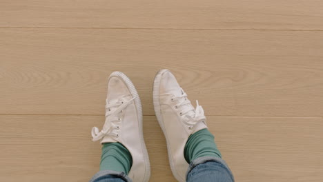 above-view-woman-wearing-white-shoes-enjoying-stylish-new-footware-standing-on-carpet-rug