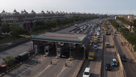 Drone-shot-flying-above-and-covering-traffic-congestion-in-a-busy-toll-gate