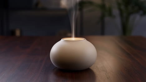 modern diffuser emitting vapor on a wooden table