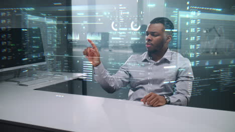 man working on a virtual interface in a modern office