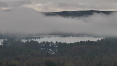 aerial view of a lake in the new hampshire wilderness. shot on an overcast day.