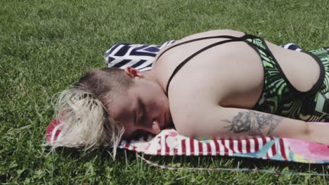 a beautiful woman relaxing while getting tan under the heat of sun in canada - close-up shot