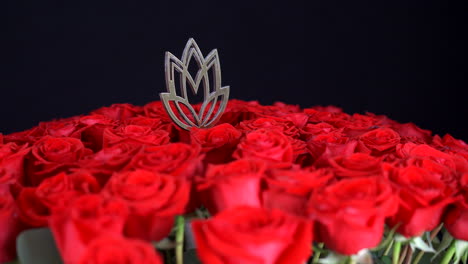 Red-roses-spinning-with-golden-lotus-decoration-black-background-close-up-shot