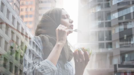 animation of asian woman in hijab enjoying salad, over cityscape