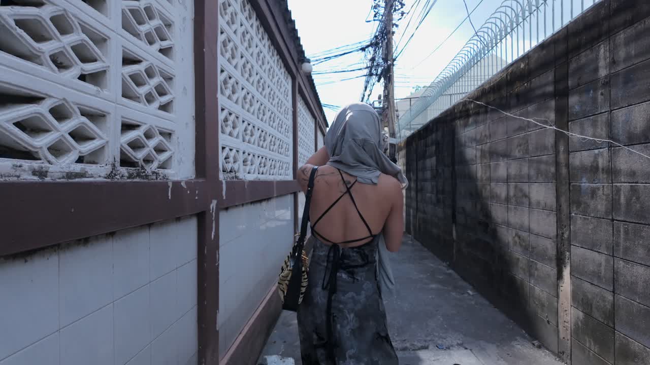 Woman walking in an alleyway