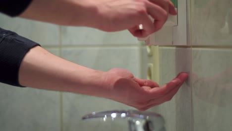 steady shot of young man washing his hands carefully with soap and hot water. close up.