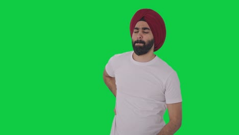 sick sikh indian man suffering from back pain green screen