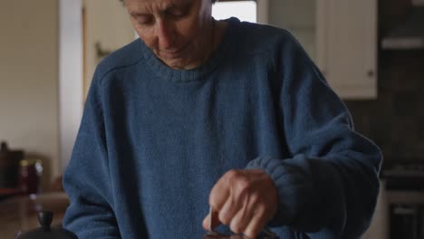 Senior-Caucasian-woman-making-coffee-at-home