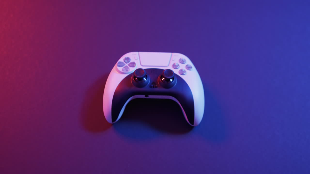 Video of close up of video game pad controller with copy space on neon background