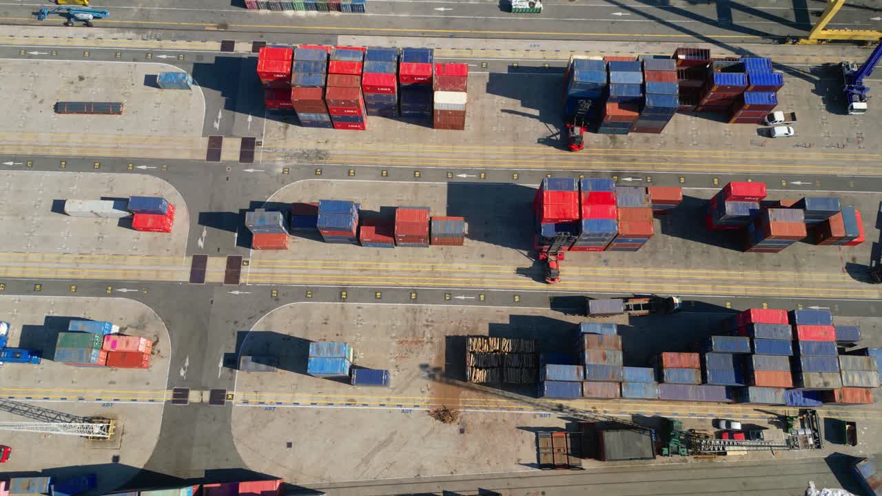 Seen from above a container terminal with trucks circulating and forklifts unloading,Lisbon,Portugal