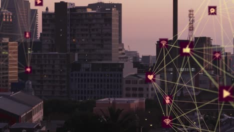 animation of two globes of digital icons spinning against aerial view of cityscape