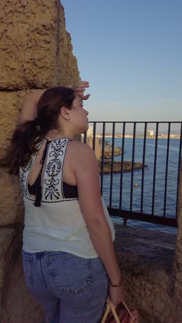 tourist waving from acre old city walls in israel