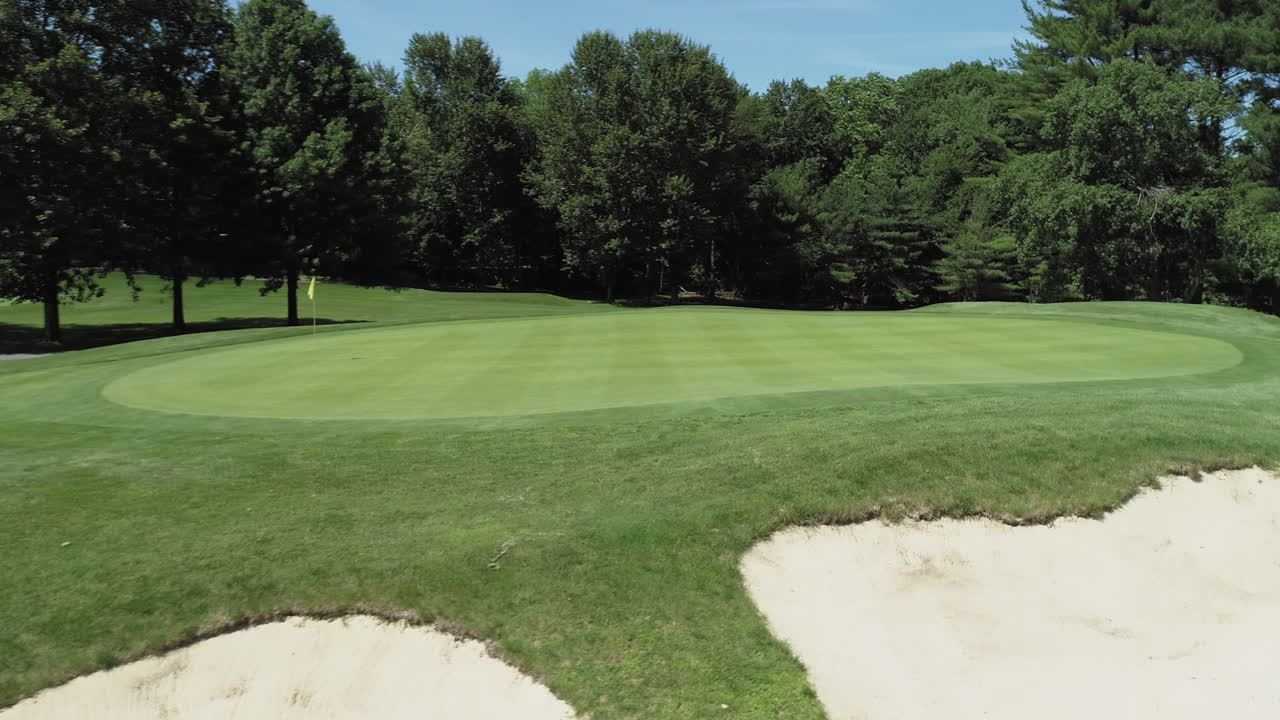 Aerial approach and circle around green hole 15, River Vale Golf Course. Beautiful sunny day.