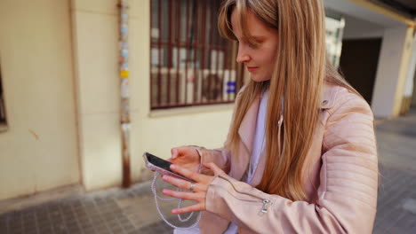 Woman using phone on the street