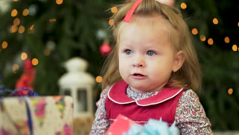 adorable little girl by christmas tree