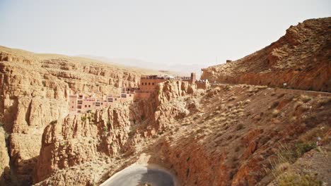 Historic-buildings-constructed-on-slope-of-rocky-cliff-in-valley-of-Atlas-Range