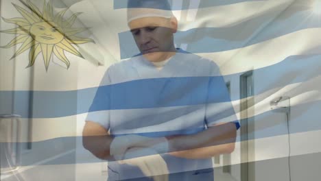 Animation-of-flag-of-uruguay-waving-over-surgeon-in-operating-theatre