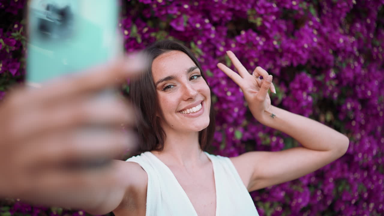 Woman taking selfie with bougainvillea flowers