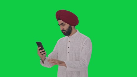 sikh indian man using phone green screen