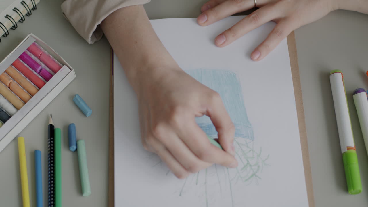 Person Drawing with Crayons