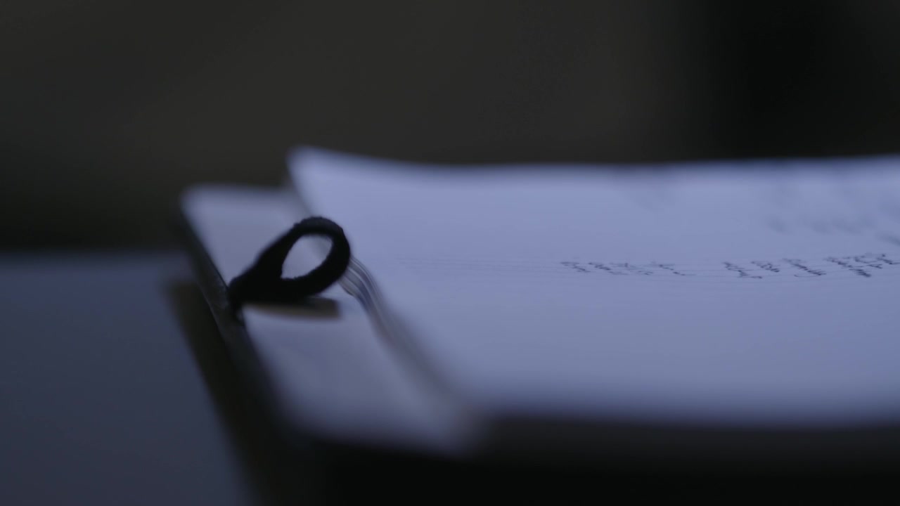 Pulling focus along the edge of a notepad.