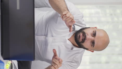 vertical video of home office worker man talking motivationally to camera.