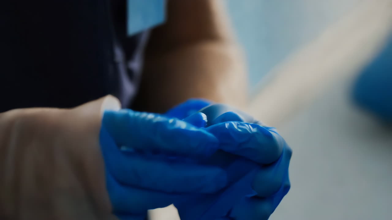 Person in blue medical gloves
