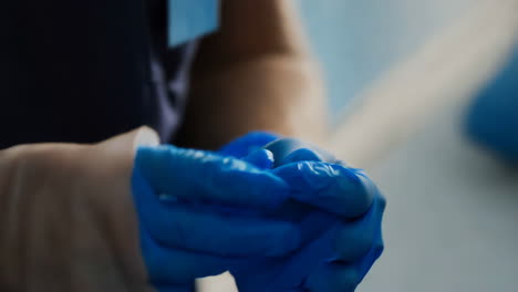 person in blue medical gloves