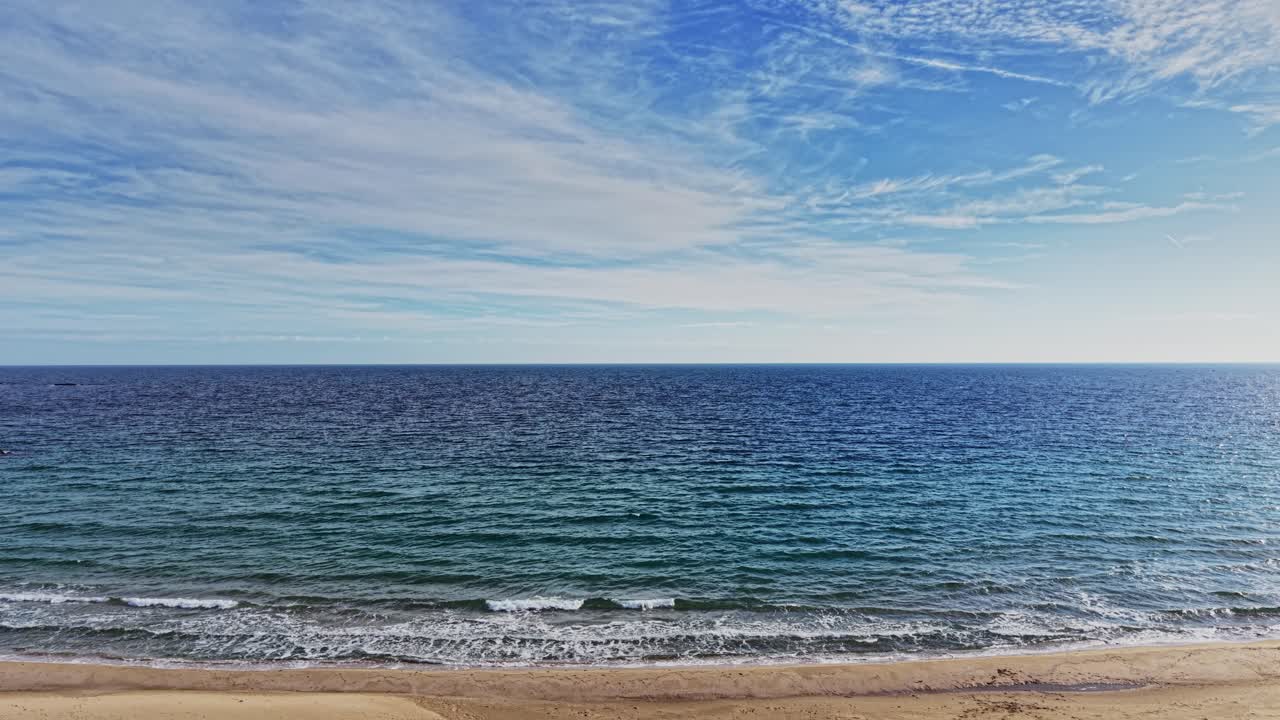 Calm coastal view from above capturing serene beach and ocean