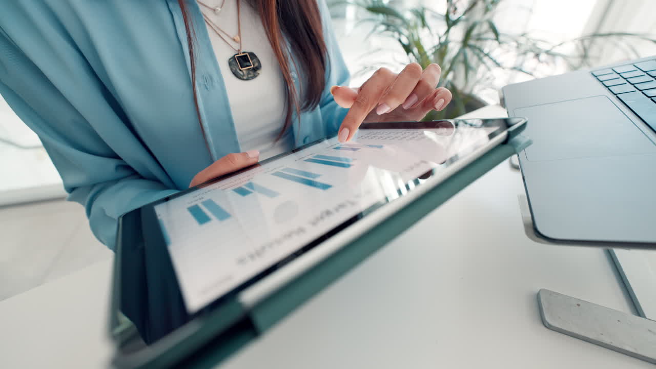 Businesswoman Analyzing Data on Tablet