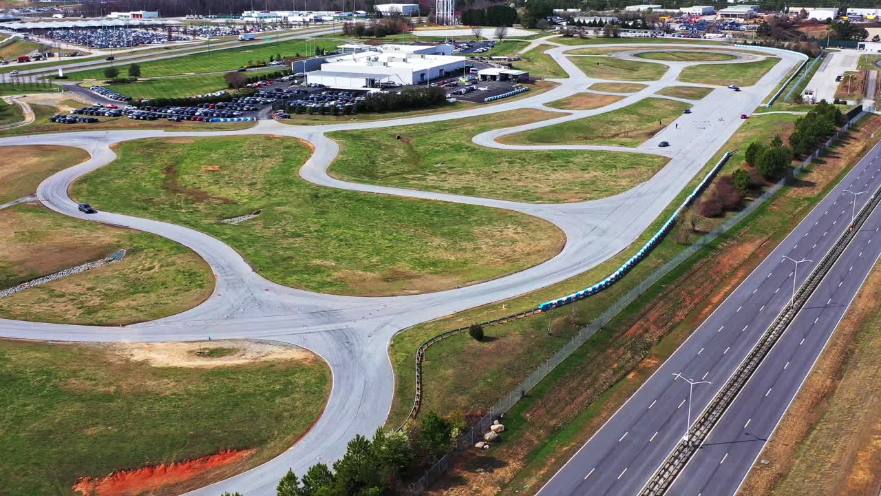 Aerial video of confidential BMW prototypes on a test track.