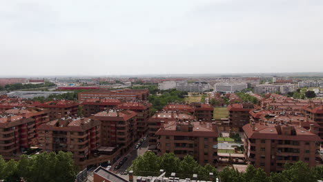 ascend over apartment building neighborhood in madrid, aerial view